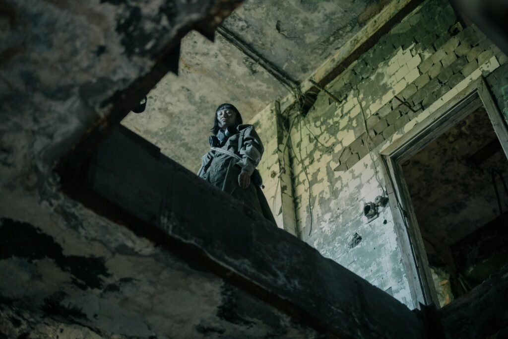 pexels-photo-4888469-4888469 A person explores the eerie atmosphere of an abandoned, dystopian building.